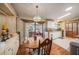 Cozy kitchen featuring wood cabinets, an adjacent eating area, and lots of counter space at 35020 Colony Hills Dr, Zephyrhills, FL 33541