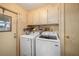 Laundry room with side by side washer and dryer and built in cabinetry above at 35020 Colony Hills Dr, Zephyrhills, FL 33541