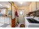 Laundry room area features a sink, cabinets, a washer, and a dryer at 35020 Colony Hills Dr, Zephyrhills, FL 33541