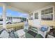 Cozy, covered porch with comfortable wicker furniture, creating an inviting outdoor living space at 35020 Colony Hills Dr, Zephyrhills, FL 33541