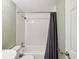 Bathroom with a white tiled shower with curtain at 4037 Chesswood Dr, Holiday, FL 34691
