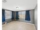 Bedroom featuring tile floors, grey walls and two bright windows at 4037 Chesswood Dr, Holiday, FL 34691