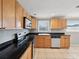 Efficient kitchen layout with ample cabinet space, tile floors, and essential appliances at 4037 Chesswood Dr, Holiday, FL 34691