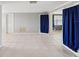 Open-concept living room with tile flooring, two doors and neutral walls at 4037 Chesswood Dr, Holiday, FL 34691