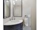 Bathroom featuring a corner sink, modern lighting, and a towel ring at 404 Westborough Ln, Safety Harbor, FL 34695