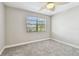 Bright bedroom with neutral walls, carpet and window overlooking a landscaped yard at 404 Westborough Ln, Safety Harbor, FL 34695