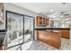 A kitchen with a breakfast bar leading to a sliding glass door at 404 Westborough Ln, Safety Harbor, FL 34695