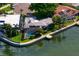 Aerial view of the property featuring a screened-in pool, dock, and waterfront access at 4464 46Th S Ave, St Petersburg, FL 33711