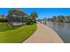 Backyard view of a screened-in pool and waterfront with a walkway and a private dock at 4464 46Th S Ave, St Petersburg, FL 33711