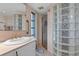 Bathroom featuring a sink with brass fixtures, a glass block shower, and neutral décor at 4464 46Th S Ave, St Petersburg, FL 33711