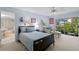 Bright bedroom features a comfortable bed, sitting area, and sliding glass doors to a garden at 4464 46Th S Ave, St Petersburg, FL 33711