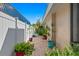 Outdoor patio area with a brick walkway, planters, and a white fence at 4464 46Th S Ave, St Petersburg, FL 33711