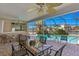 Covered patio featuring brick flooring, ceiling fans, and views of the pool and canal at 4464 46Th S Ave, St Petersburg, FL 33711