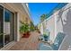 Outdoor patio with seating surrounded by a white fence, various potted plants, and a brick walkway at 4464 46Th S Ave, St Petersburg, FL 33711