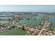 Panoramic aerial view of a coastal community with canals, featuring luxurious homes with private docks and boat access at 448 79Th S St, St Petersburg, FL 33707