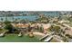Stunning waterfront home with a private dock and a boat lift, nestled among lush palm trees and tropical landscaping at 448 79Th S St, St Petersburg, FL 33707