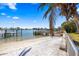Backyard beach with a view of the waterfront, complemented by lush palm trees at 448 79Th S St, St Petersburg, FL 33707