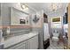 Stylish bathroom with chandelier, decorative mirror and a shower with curtain at 448 79Th S St, St Petersburg, FL 33707