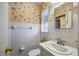 Clean bathroom with palm tree wallpaper, vanity and toilet in a well-lit space at 448 79Th S St, St Petersburg, FL 33707