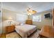 Well-lit bedroom with a queen bed, ceiling fan, and dresser at 448 79Th S St, St Petersburg, FL 33707