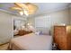 Cozy bedroom featuring neutral tones, ceiling fan, and mirrored closet doors at 448 79Th S St, St Petersburg, FL 33707