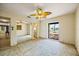 Bright bedroom with a ceiling fan, mirrored closet, and door that opens to a backyard at 448 79Th S St, St Petersburg, FL 33707