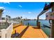 Waterfront dock featuring a bench and boat lift, perfect for enjoying waterfront living on a sunny day at 448 79Th S St, St Petersburg, FL 33707