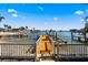 View of the wooden dock leading to the water with a quaint beach area to the side of the property at 448 79Th S St, St Petersburg, FL 33707