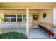 Charming front porch area with a decorative wreath, seating, and well-manicured landscaping at 448 79Th S St, St Petersburg, FL 33707