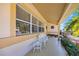 Inviting front porch with a seating bench and view of lush landscaping at 448 79Th S St, St Petersburg, FL 33707