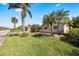 Well-maintained front lawn and landscaping of a charming home on a sunny day at 448 79Th S St, St Petersburg, FL 33707
