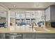 Bright kitchen area with an open view to the living room and large sink at 448 79Th S St, St Petersburg, FL 33707