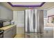 Close up on the kitchen, showing stainless steel refrigerator, countertops, and modern cabinets at 448 79Th S St, St Petersburg, FL 33707