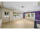 Bright and airy living room boasting terrazzo floors, large windows, and a decorative glass-accented front door at 448 79Th S St, St Petersburg, FL 33707