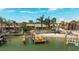 Exterior view of a waterfront home with a private dock, beach and lush landscaping at 448 79Th S St, St Petersburg, FL 33707