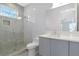 This modern bathroom features a glass enclosed shower, vanity with drawers and a large mirror at 4604 W Lowell Ave, Tampa, FL 33629