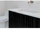 Modern bathroom features a dark vanity with marble countertop, decorative wall, and gold hardware at 4604 W Lowell Ave, Tampa, FL 33629