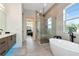 Spacious bathroom with a luxurious soaking tub, walk-in shower, and stylish vanity with black faucet at 4604 W Lowell Ave, Tampa, FL 33629
