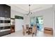 Bright dining area with modern light fixture, table with four chairs, and sliding glass doors to the patio at 4604 W Lowell Ave, Tampa, FL 33629