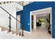 Elegant foyer featuring staircase with glass railings and view into the living room at 4604 W Lowell Ave, Tampa, FL 33629