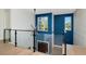 Upstairs hallway with modern lighting, hardwood floors, a glass enclosed railing and colorful walls at 4604 W Lowell Ave, Tampa, FL 33629