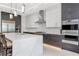 Modern kitchen features an island with marble countertop, stainless steel appliances, and two-tone cabinetry at 4604 W Lowell Ave, Tampa, FL 33629