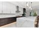 A luxury kitchen featuring marble countertops, modern appliances, and two-tone cabinets at 4604 W Lowell Ave, Tampa, FL 33629