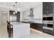 Modern kitchen features an island with marble countertop, stainless steel appliances, and two-tone cabinetry at 4604 W Lowell Ave, Tampa, FL 33629