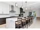 A chef's kitchen with white marble countertops, dark lower cabinets, and pendant lighting over the island at 4604 W Lowell Ave, Tampa, FL 33629