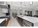 A modern kitchen with large island, stainless steel appliances, and an adjacent dining area at 4604 W Lowell Ave, Tampa, FL 33629