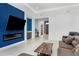 A sleek fireplace and television are built into an accent wall in this stylish living room at 4604 W Lowell Ave, Tampa, FL 33629