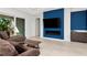 Living area with sliders to lanai, a modern fireplace, and a contemporary accent wall at 4604 W Lowell Ave, Tampa, FL 33629