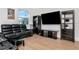 Living room featuring hardwood floors, comfortable seating, a modern ceiling fan, and a backyard view at 4604 W Lowell Ave, Tampa, FL 33629