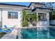 Back of house featuring a serene pool and patio area perfect for outdoor relaxation and entertainment at 4604 W Lowell Ave, Tampa, FL 33629